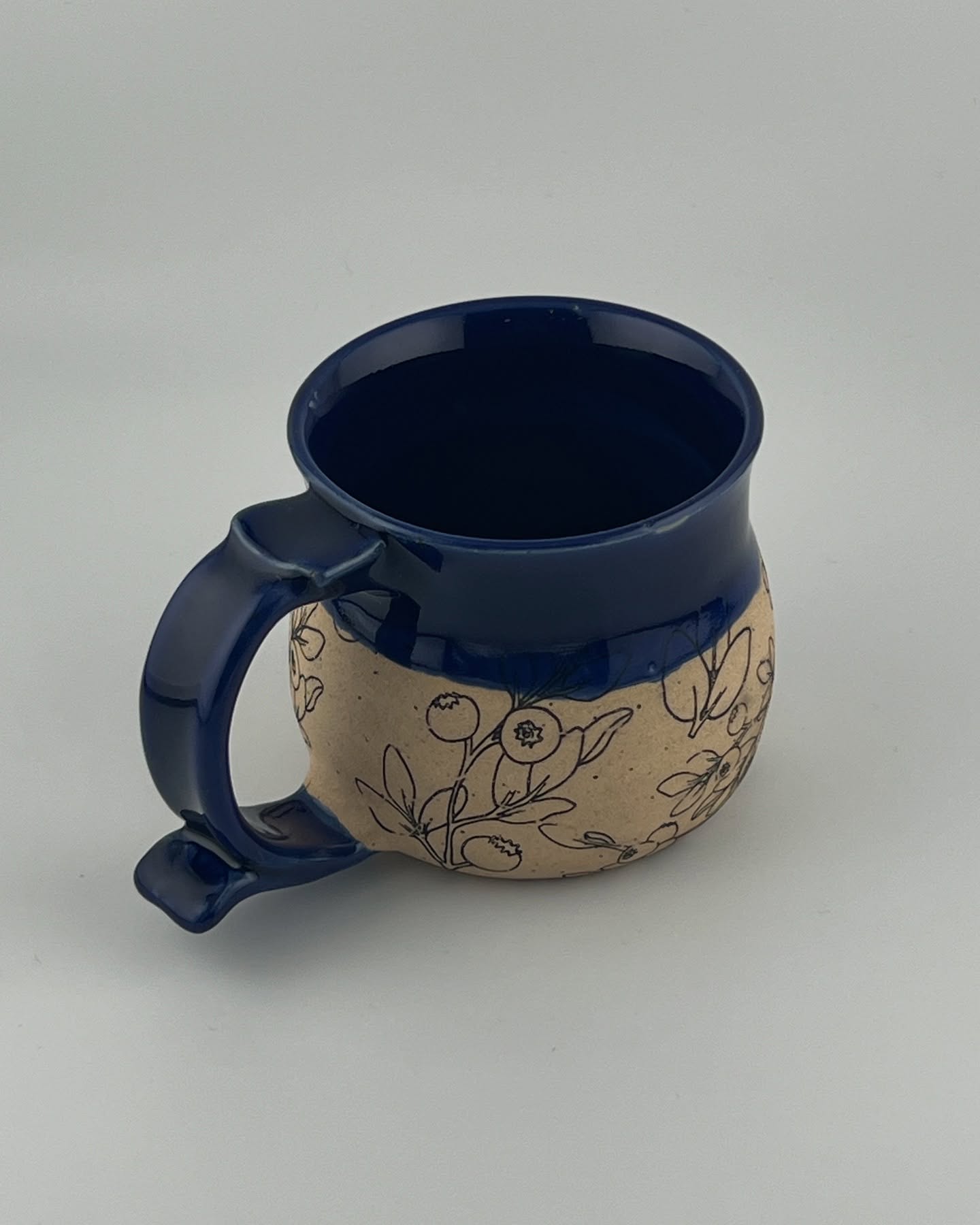 This mug has Blue Iris glaze on Roo clay. The blueberry underglaze transfers are from @elantransfers and are not my original artwork but they are adorable. Available June 21st, at the @newalbanyfarmersmarket 8-12