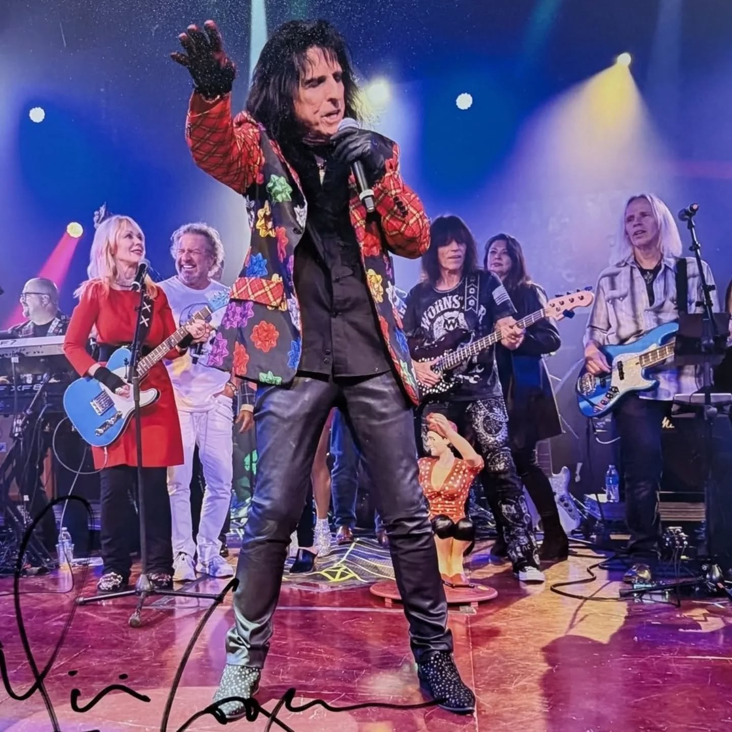 Recently came across this photo as an auction item when we played #AliceCooper 's #Coopstock show earlier this year. It was taken at the 2023 #ChristmasPudding show and in the pic I'm playing bass, along with bass legend #RudySarzo, on the show closer where Alice brought back out his guest artists #SammyHagar, #NancyWilson of #Heart & Rudy (who was there with Quiet Riot). We had just backed up everyone on the show (except for obviously Quiet Riot) when this pic was taken. I look at this and think that my 13 yr old self would think what kind of crazy universe am I living in. And I'm thinking just how grateful I am to have gotten to (and still) live my dreams over and over. Makes me think back to the kid who was starting out by learning to play songs like