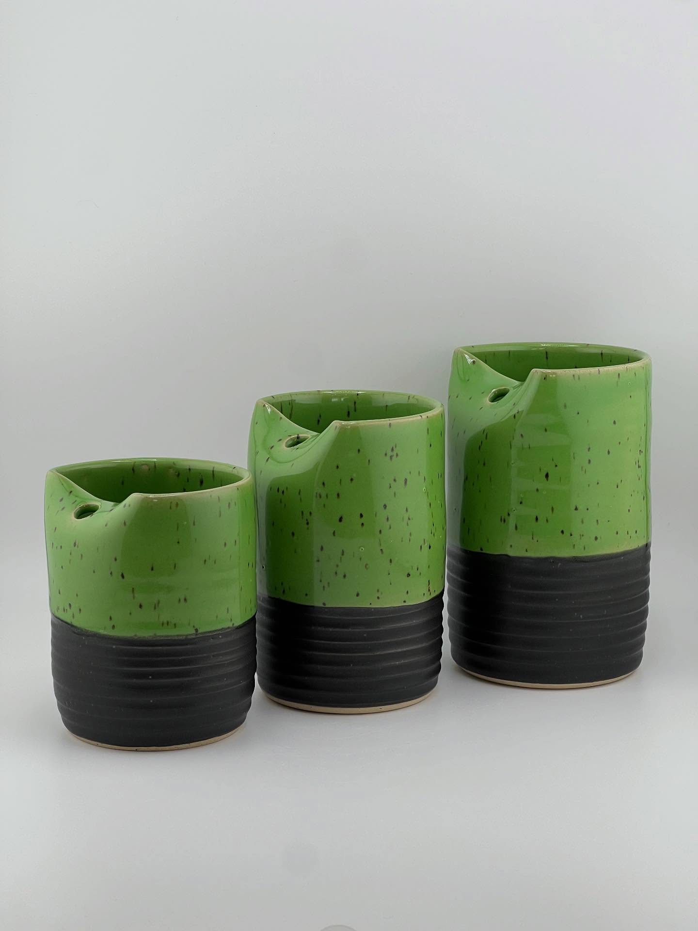 This little family of Cold Cups is really just the cutest little set I’ve ever made. Does your family of 3 enjoy a healthy smoothie each morning? If so, make it matching. They are made of Roo clay. The glaze is Satin Black on the bottom and Sweet Pea on top and inside. Full disclosure: on the largest cup we have what is called ‘crawling’ in the pottery world. Some of the glaze pulled away from a spot where the glazes was applied too thick. That cup will be discounted because of esthetics, however the defect doesn’t take away from the safety of the cup. You can see the crawling in one of the photos.
