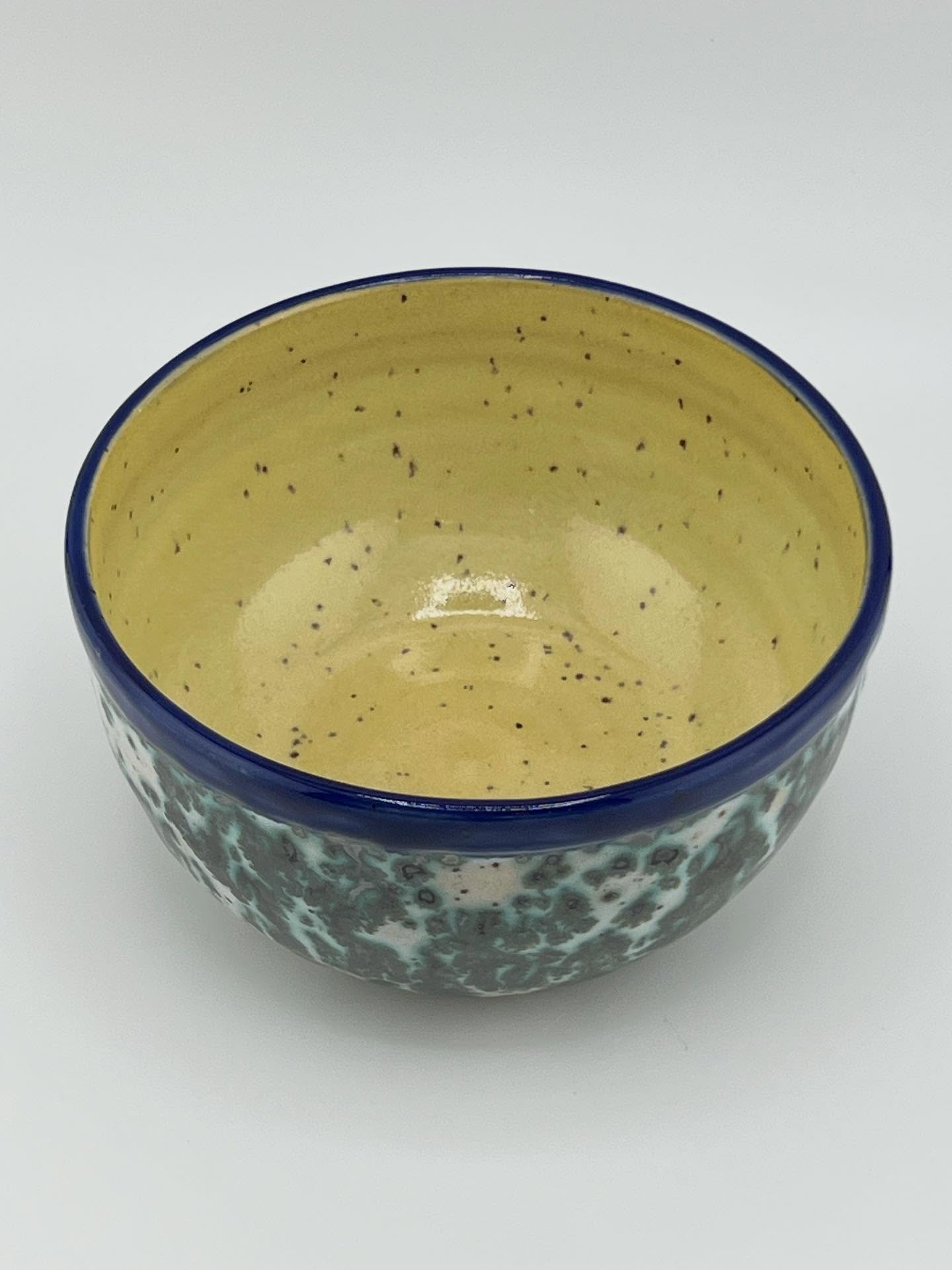 This bowl is wheel thrown with Roo clay. The glaze is Blue Iris on the rim, Green Jasper on the outside and Frosted Lemon on the inside.