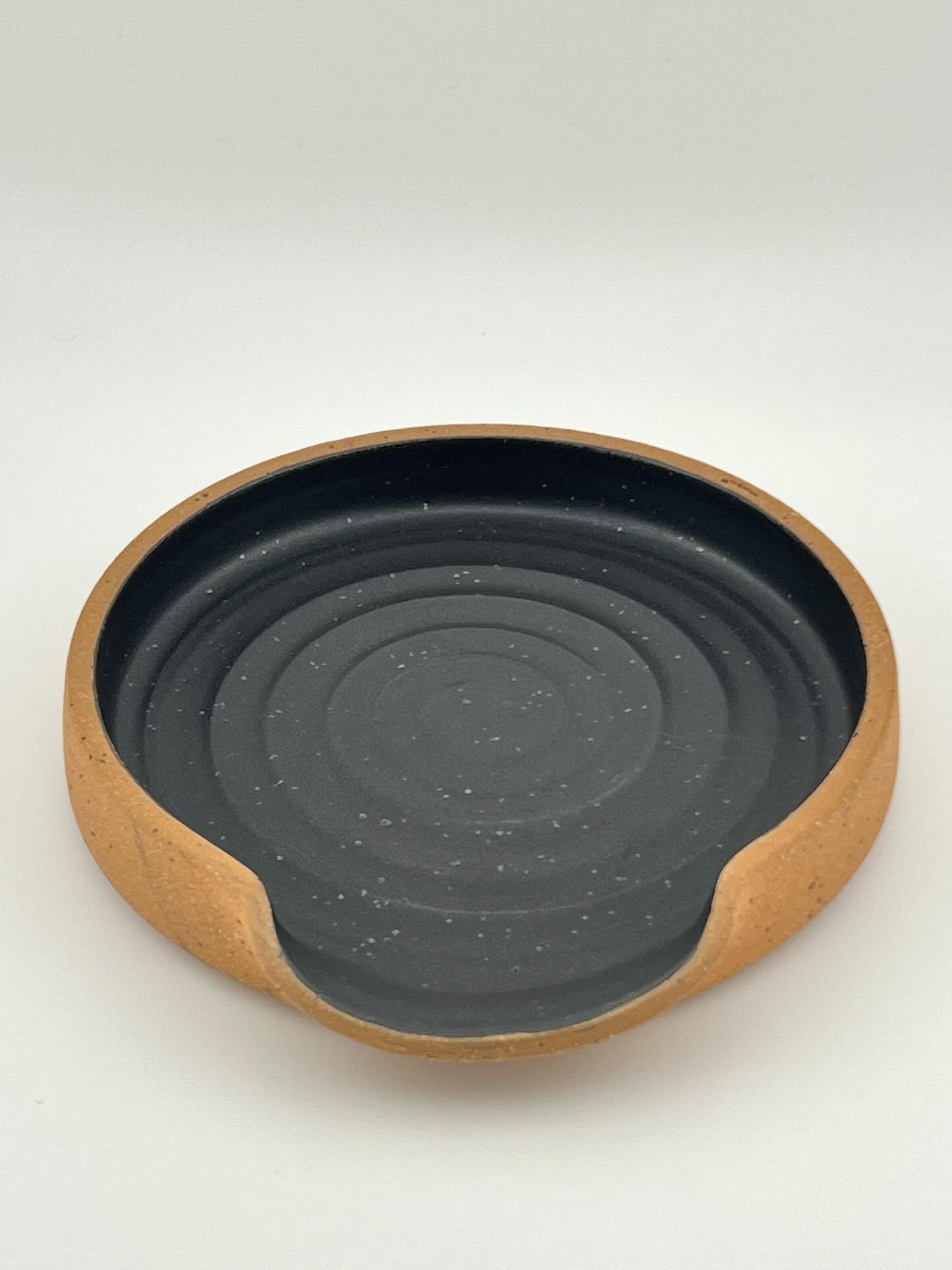 A collection of Spoon Rests. Keep your kitchen counters clean by keeping this next to your stove top and putting your spatulas on it. They are dishwasher safe just like the rest of my pottery. Glazes are Satin Black, Cosmos, Turquoise Jewel, and Sunflower. Clay is Speckled Turtle.